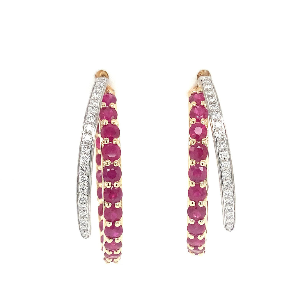 A pair of gold hoop earrings with rows of round-cut pinkish-red rubies and white diamonds, shown against a plain white background.