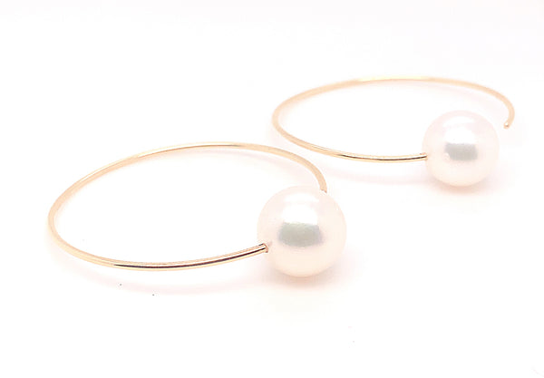 white freshwater pearl on handmade round wire earrings in 14k of yellow gold