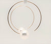 white freshwater pearl on handmade round wire earrings in 14k of yellow gold