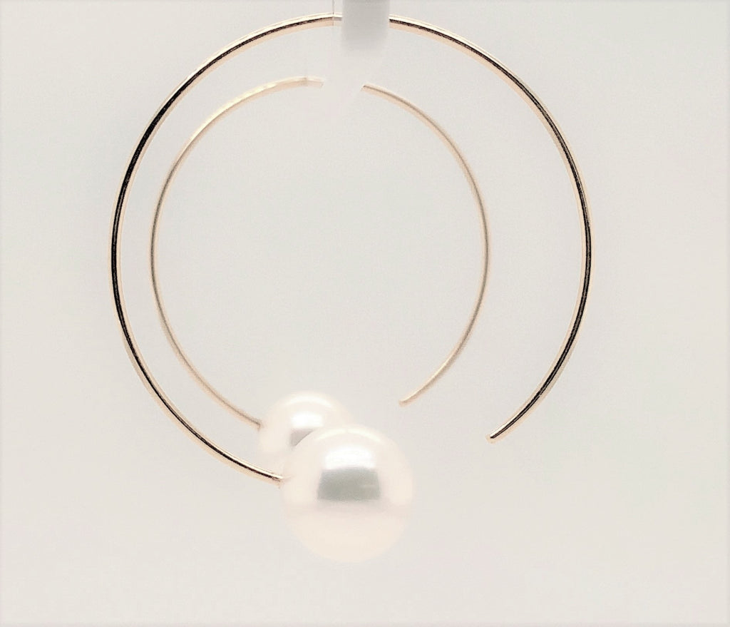 white freshwater pearl on handmade round wire earrings in 14k of yellow gold