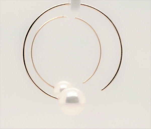 white freshwater pearl on handmade round wire earrings in 14k of yellow gold