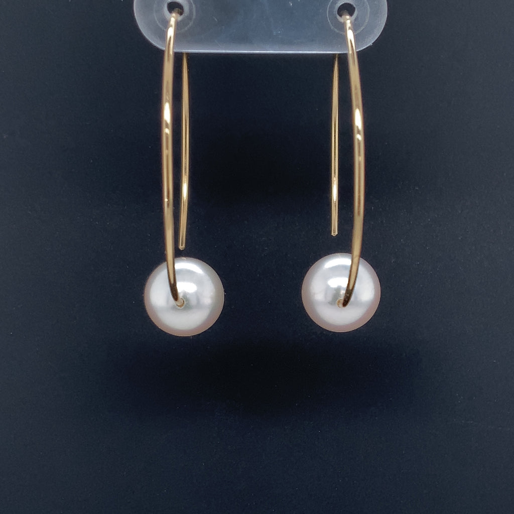 white freshwater pearl on handmade round wire earrings in 14k of yellow gold