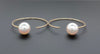 white freshwater pearl on handmade round wire earrings in 14k of yellow gold