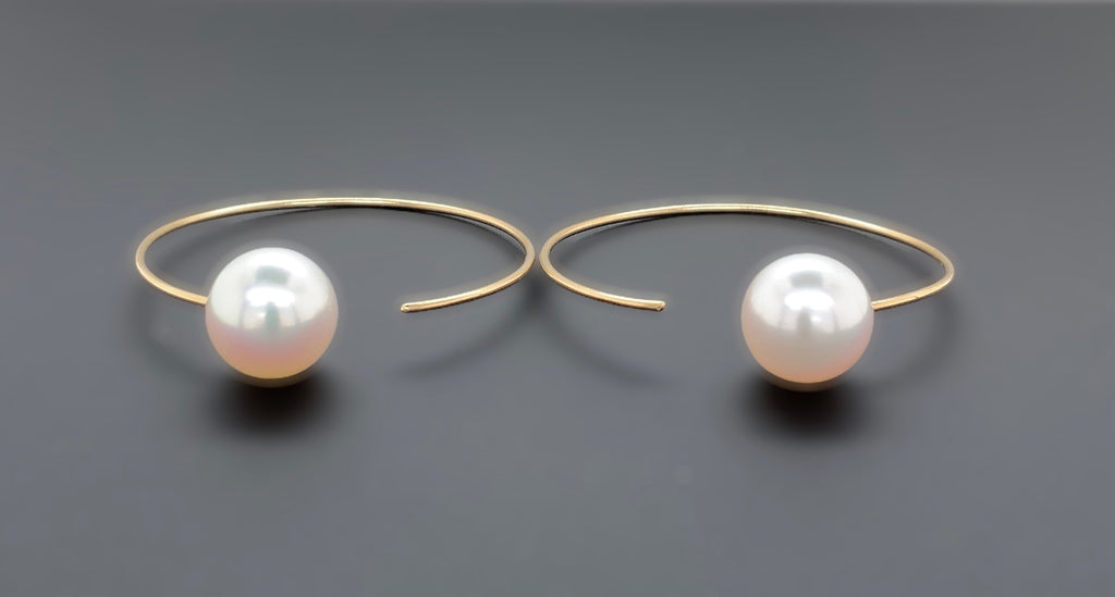 white freshwater pearl on handmade round wire earrings in 14k of yellow gold
