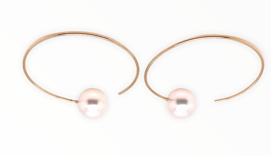 white freshwater pearl on handmade round wire earrings in 14k of yellow gold