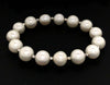 white fresh water pearl bracelet with 14kt white gold multifaceted 3mm beads on stretchable cord
