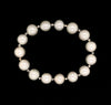 white fresh water pearl bracelet with 14kt white gold multifaceted 3mm beads on stretchable cord