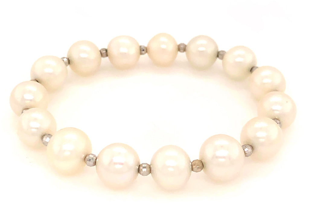 white fresh water pearl bracelet with 14kt white gold multifaceted 3mm beads on stretchable cord