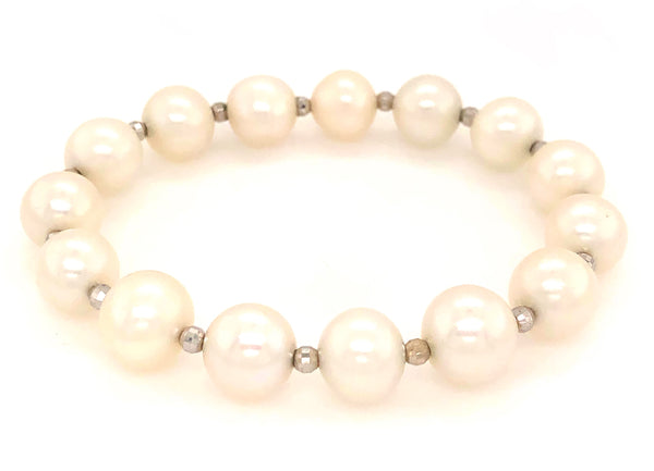 white fresh water pearl bracelet with 14kt white gold multifaceted 3mm beads on stretchable cord