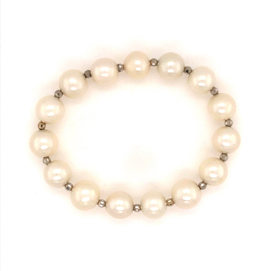 white fresh water pearl bracelet with 14kt white gold multifaceted 3mm beads on stretchable cord