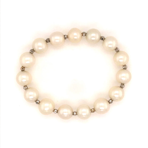 white fresh water pearl bracelet with 14kt white gold multifaceted 3mm beads on stretchable cord